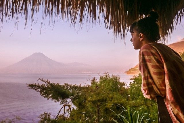 woman looking at lake atitlan and volcano